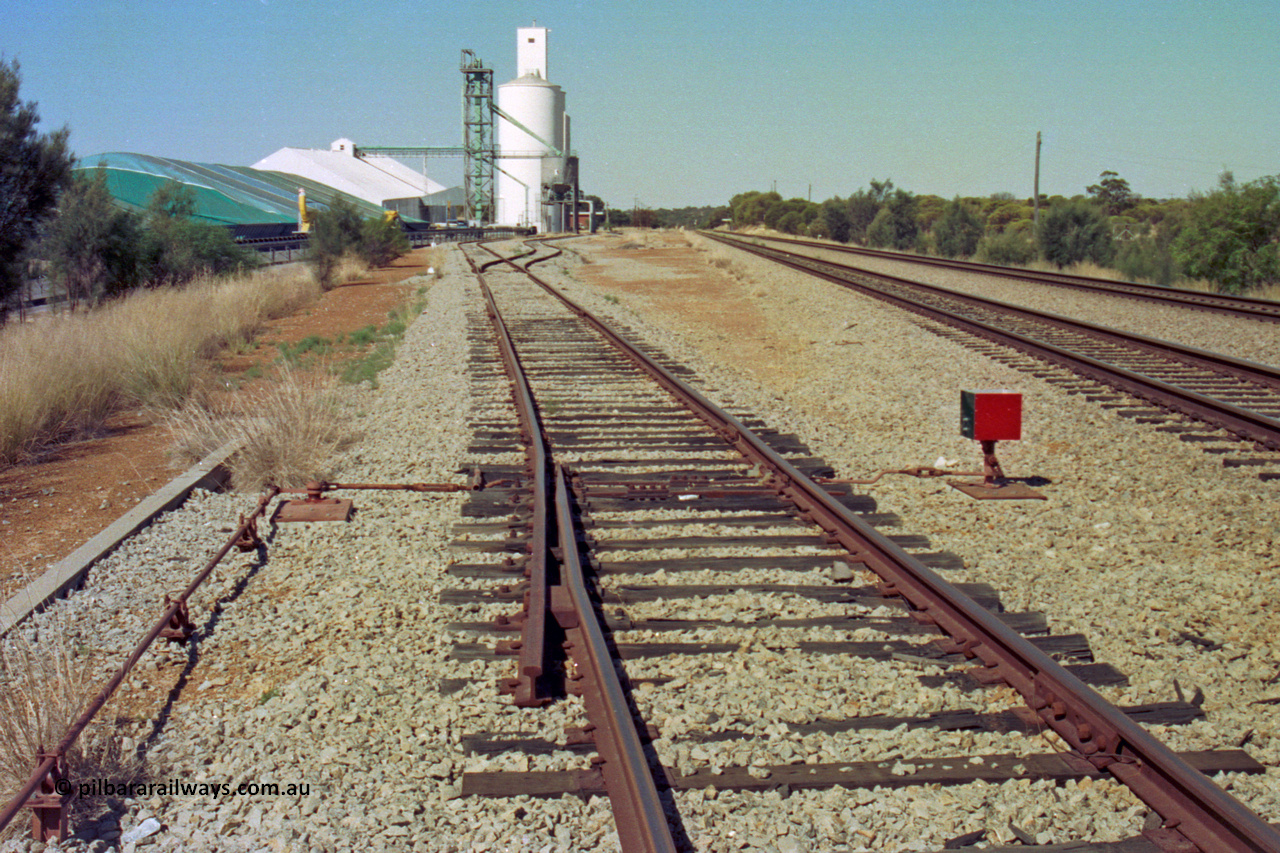 202-14
Meckering, view looing east at the catch points and dwarf indicator at the west end of the goods siding, grain bunker and silos with the goods shed and station visible in the distance.
