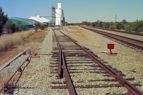 202-14
Meckering, view looing east at the catch points and dwarf indicator at the west end of the goods siding, grain bunker and silos with the goods shed and station visible in the distance.
