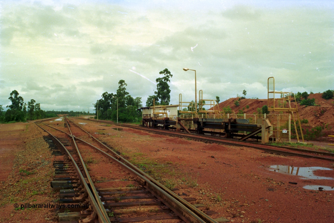 210-03
Weipa, Lorim Point, Comalco rail dump station, view of the hydraulic jacking or indexing arms located on the Andoom side of the unloader, used to position the train for unloading.
