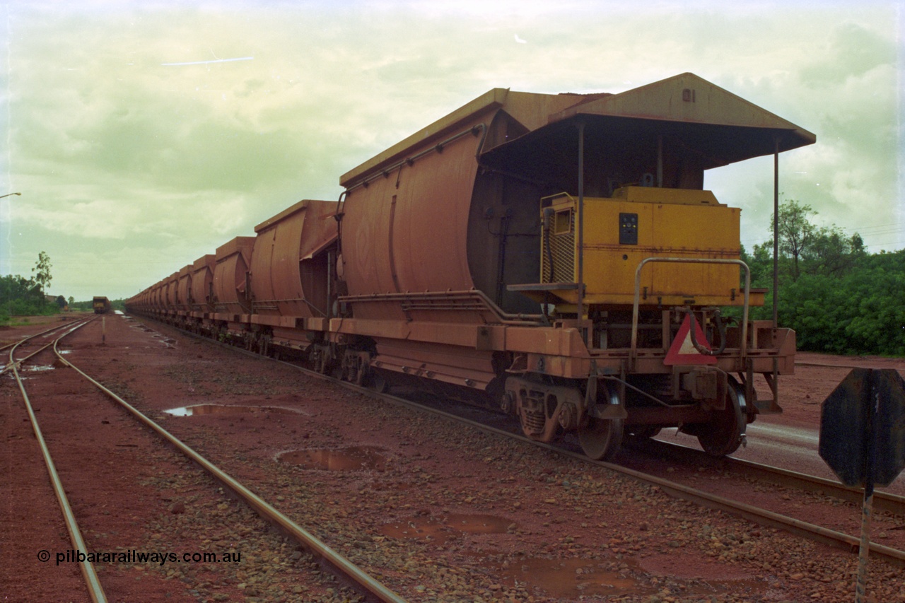 210-05
Weipa, Lorim Point, rake of loaded cars with a compressor car on the rear of the consist closest to camera.
