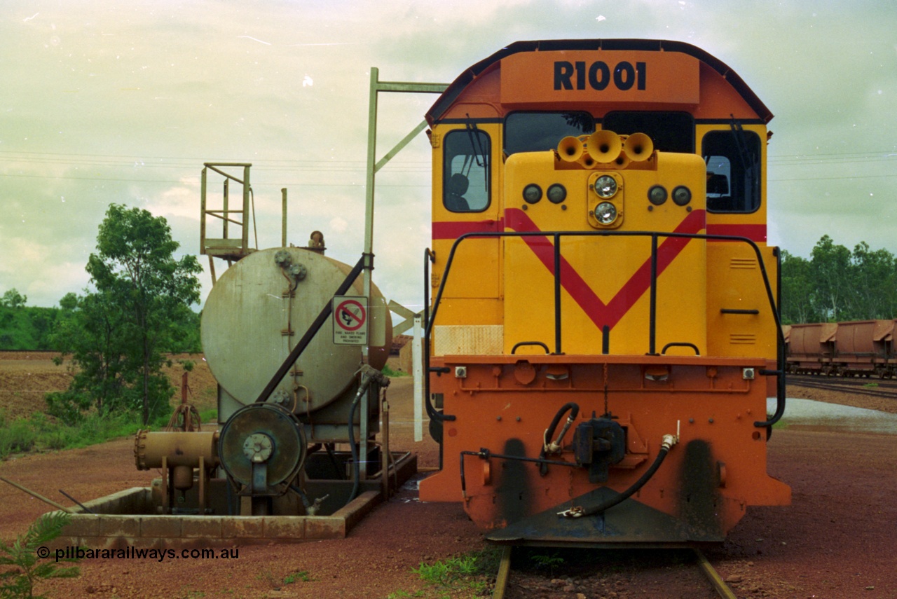 210-07
Weipa, Lorim Point railway workshops, front view of Comalco R 1001 loco Clyde Engineering EMD model GT26C serial 72-752 while is sits at the fuel point, items of note are the second 'tropical roof' and the five chime horn cut into the nose. Also as the Weipa locomotives don't work in MU there is only the train brake hose and the main res hose for charging the belly dump discharge doors.
Keywords: R1001;Clyde-Engineering;EMD;GT26C;72-752;1.001;Comalco;