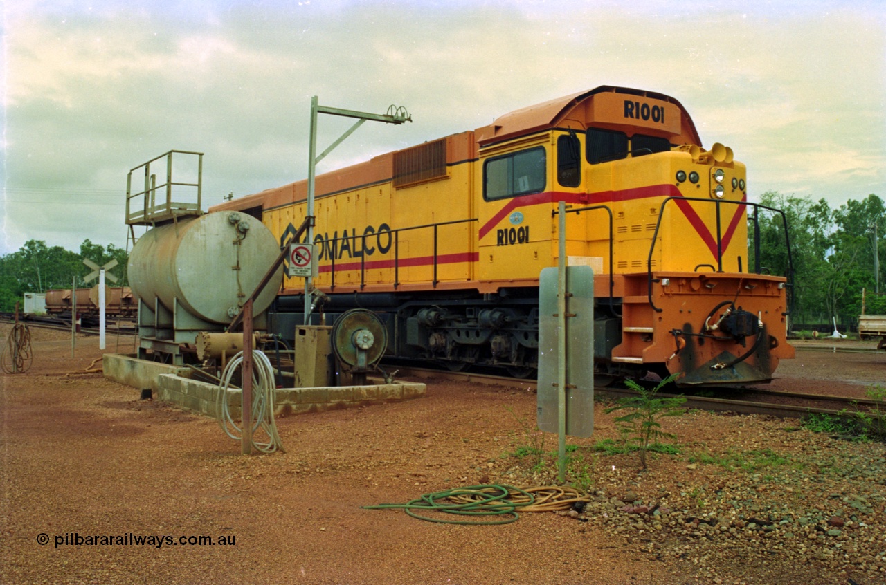 210-08
Weipa, Lorim Point railway workshops, driver side view of Comalco R 1001 loco Clyde Engineering EMD model GT26C serial 72-752 while is sits at the fuel point, items of note are the second 'tropical roof' and the five chime horn cut into the nose. Also noticeable, the units don't have dynamic brakes fitted so there is no brake 'blister' in the middle of the hood like the WAGR L or VR C classes which are also GT26C models.
Keywords: R1001;Clyde-Engineering;EMD;GT26C;72-752;1.001;Comalco;