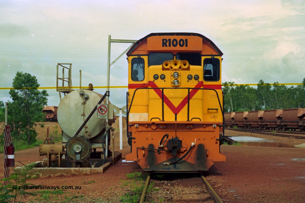 210-19
Weipa, Lorim Point, railway workshops, front view of Comalco R 1001 loco Clyde Engineering EMD model GT26C serial 72-752 while is sits at the fuel point, items of note are the second 'tropical roof' and the five chime horn cut into the nose. Also as the Weipa locomotives don't work in MU there is only the train brake hose and the main res hose for charging the belly dump discharge doors.
Keywords: R1001;Clyde-Engineering;EMD;GT26C;72-752;1.001;Comalco;