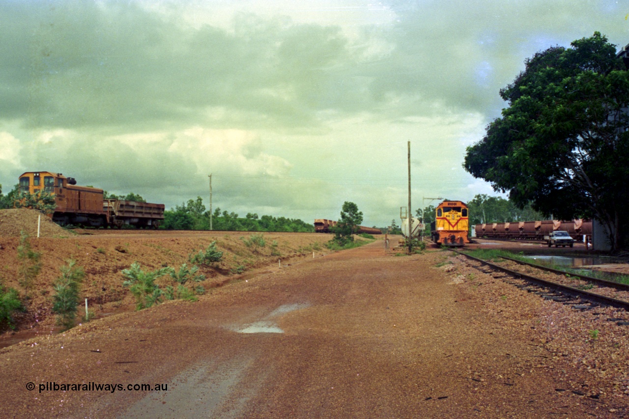 210-25
Weipa, Lorim Point railway workshops, overview looking east, shunt loco EMD model NW2 R 1003 and Difco side-dump on the left, Clyde Engineering EMD model GT26C R 1001 is at the fuel point. Workshop building at the right.
