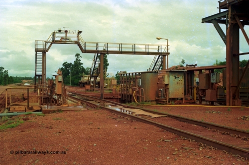 210-02
Weipa, Lorim Point, Comalco rail dump station, view looking towards Andoom Mine, shows inspection walkway and opening for unloading hopper, the waggons are discharged on the right track.
