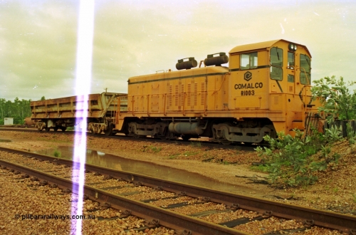 210-10
Weipa, Lorim Point railway workshops. Comalco shunt engine R 1003 coupled to a Difco side dump waggon. R 1003 is an Electro Motive built NW2 model with serial number 4114 and frame number of E761-8 was built in November 1946 at La Grange originally for Canadian National with road number 7943. Sold to Comalco in December 1975 and entered service in 1976. This unit was subsequently scrapped in 2000.
Keywords: R1003;EMD;NW2;4114;E761-8;Comalco;Canadian-National;