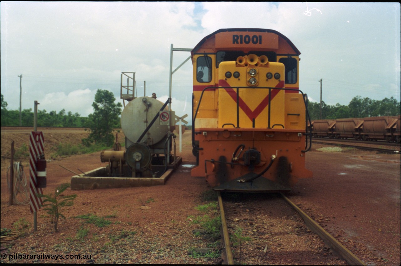 211-24
Weipa, Lorim Point railway workshops, front view of Comalco R 1001 loco Clyde Engineering EMD model GT26C serial 72-752 while is sits at the fuel point, items of note are the second 'tropical roof' and the five chime horn cut into the nose. Also as the Weipa locomotives don't work in MU there is only the train brake hose and the main res hose for charging the belly dump discharge doors.
Keywords: R1001;Clyde-Engineering;EMD;GT26C;72-752;1.001;Comalco;