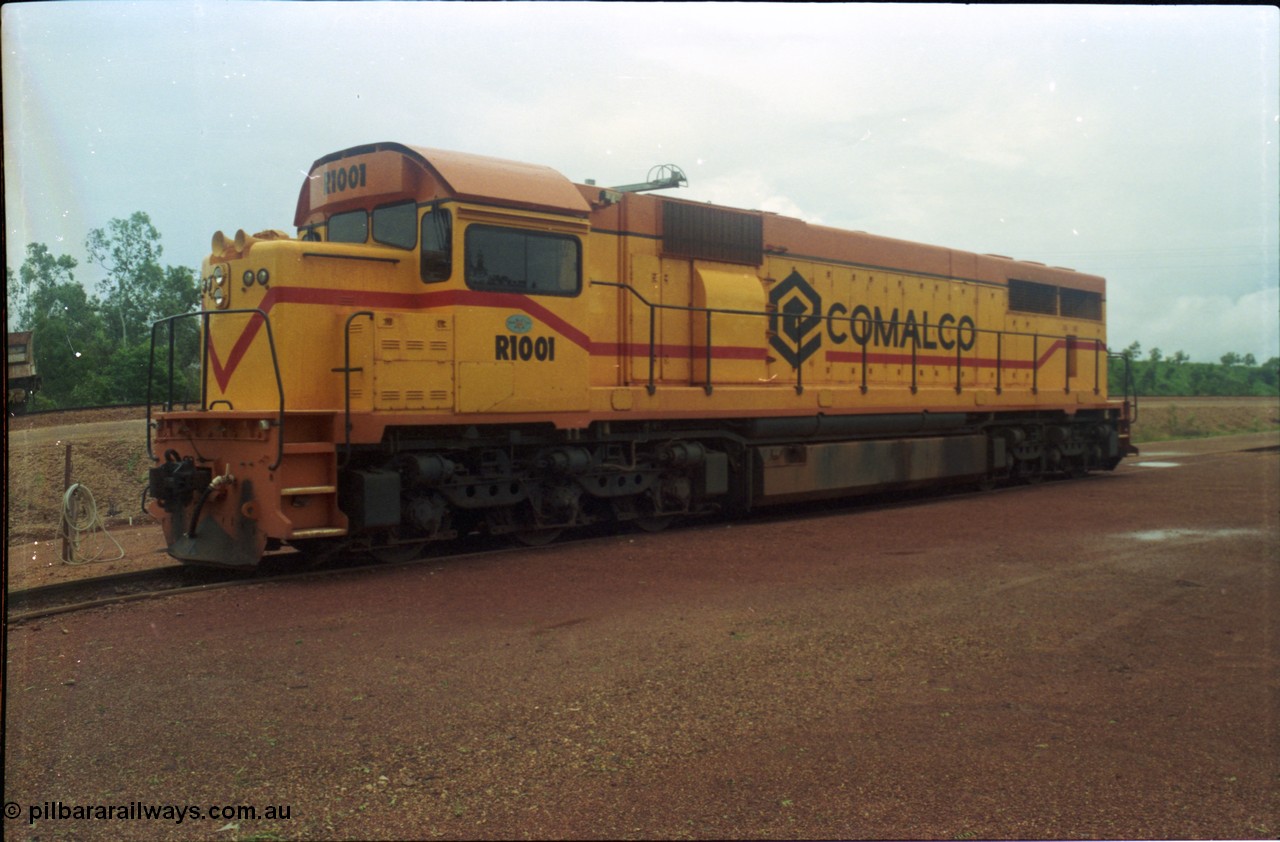 211-26
Weipa, Lorim Point railway workshops, 3/4 RHS or observer's side view of Comalco R 1001 loco Clyde Engineering EMD model GT26C serial 72-752 while is sits at the fuel point, items of note are these units were setup to have the long hood leading, the CCTV camera looking down the long hood, the second 'tropical roof' and the five chime horn cut into the nose. Also noticeable, the units don't have dynamic brakes fitted so there is no brake 'blister' in the middle of the hood like you see on the WAGR L or VR C classes which are also GT26C models.
Keywords: R1001;Clyde-Engineering;EMD;GT26C;72-752;1.001;Comalco;