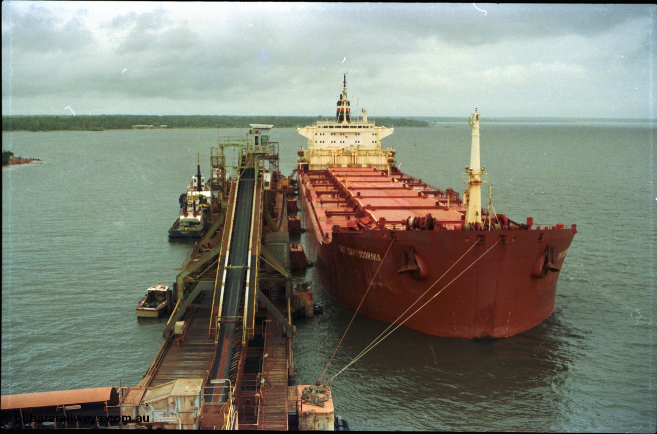 211-32
Weipa, Lorim Point overview of no. 2 bauxite berth looking south east, line boat, tug boats, no. 2 ship loader and the TNT Capricornia, a coal fired 75,500-dwt bulk carrier built by Italcantieri for TNT Bulkships trade run between Gladstone and Weipa.
