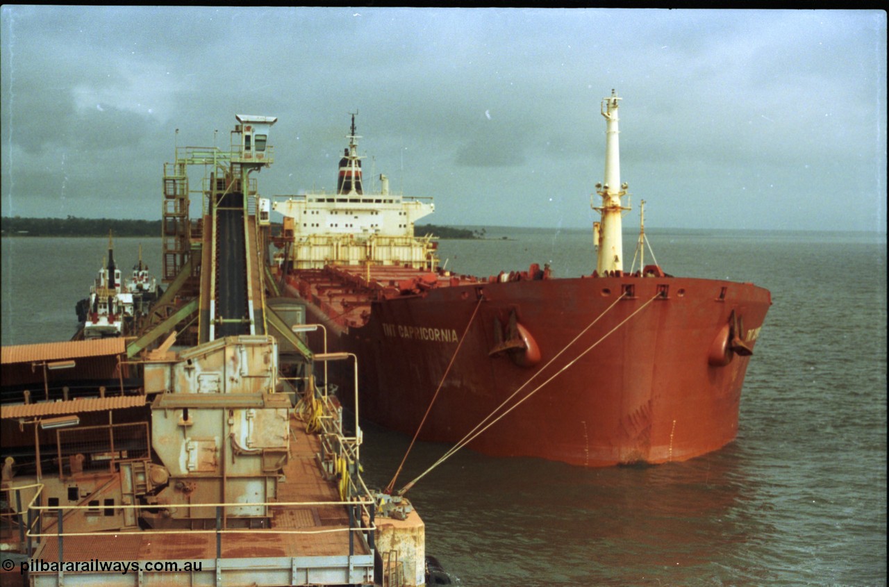 211-35
Weipa, Lorim Point overview of no. 2 bauxite berth looking south east, tug boats, no. 2 ship loader and the TNT Capricornia, a coal fired 75,500-dwt bulk carrier built by Italcantieri for TNT Bulkships trade run between Gladstone and Weipa.
