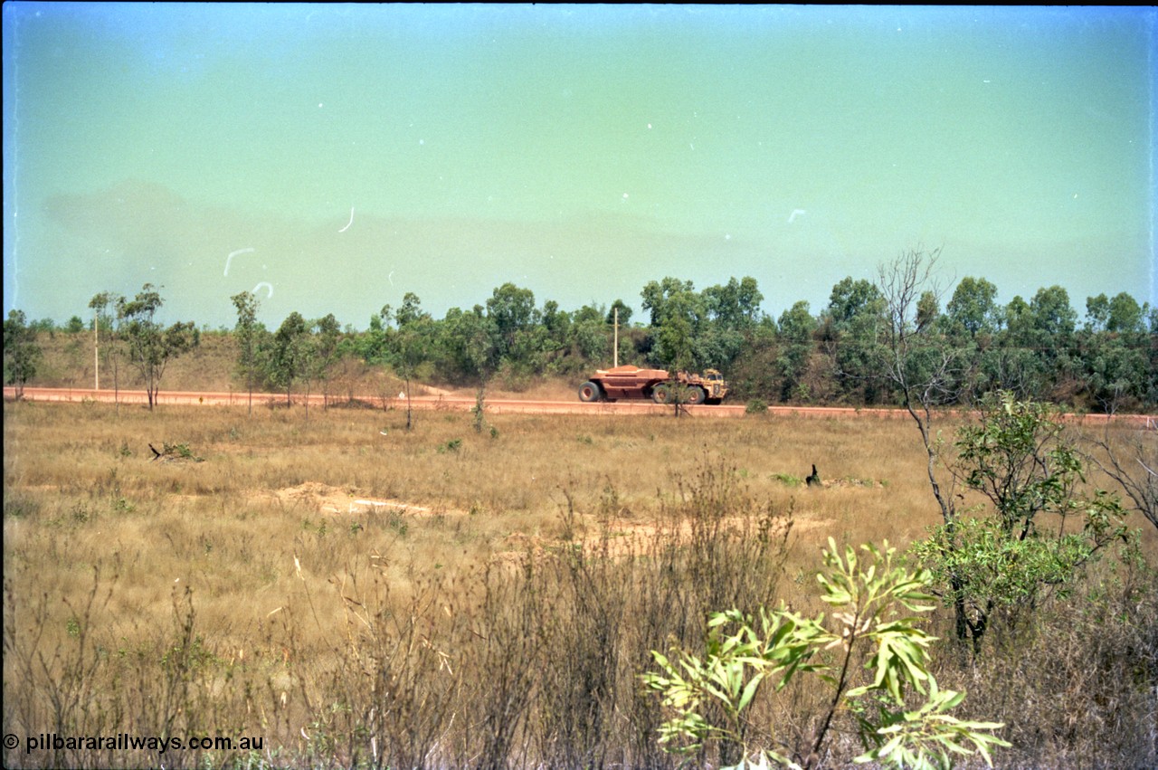212-04
Weipa, Lorim Point, view of articulated haulpak on haul road from overbridge.
