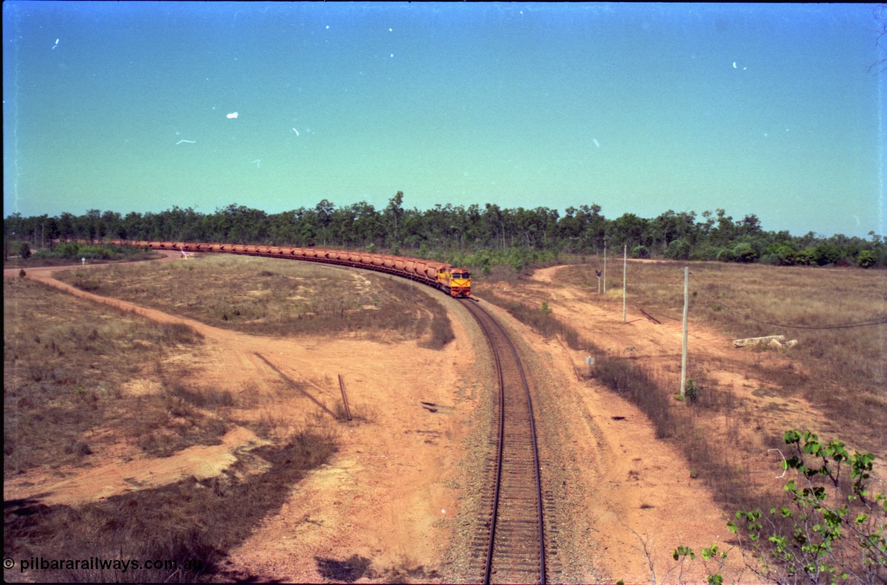 212-11
Weipa, a loaded train from Andoom Mine rounds the curve on approach to Lorim Point behind Comalco R 1004 Clyde Engineering EMD JT26C serial 90-1277 which is former Goldsworthy Mining loco GML 10.
Keywords: R1004;Clyde-Engineering-Kelso-NSW;EMD;JT26C;90-1277;Comalco;GML10;Cinderella;GML-class;