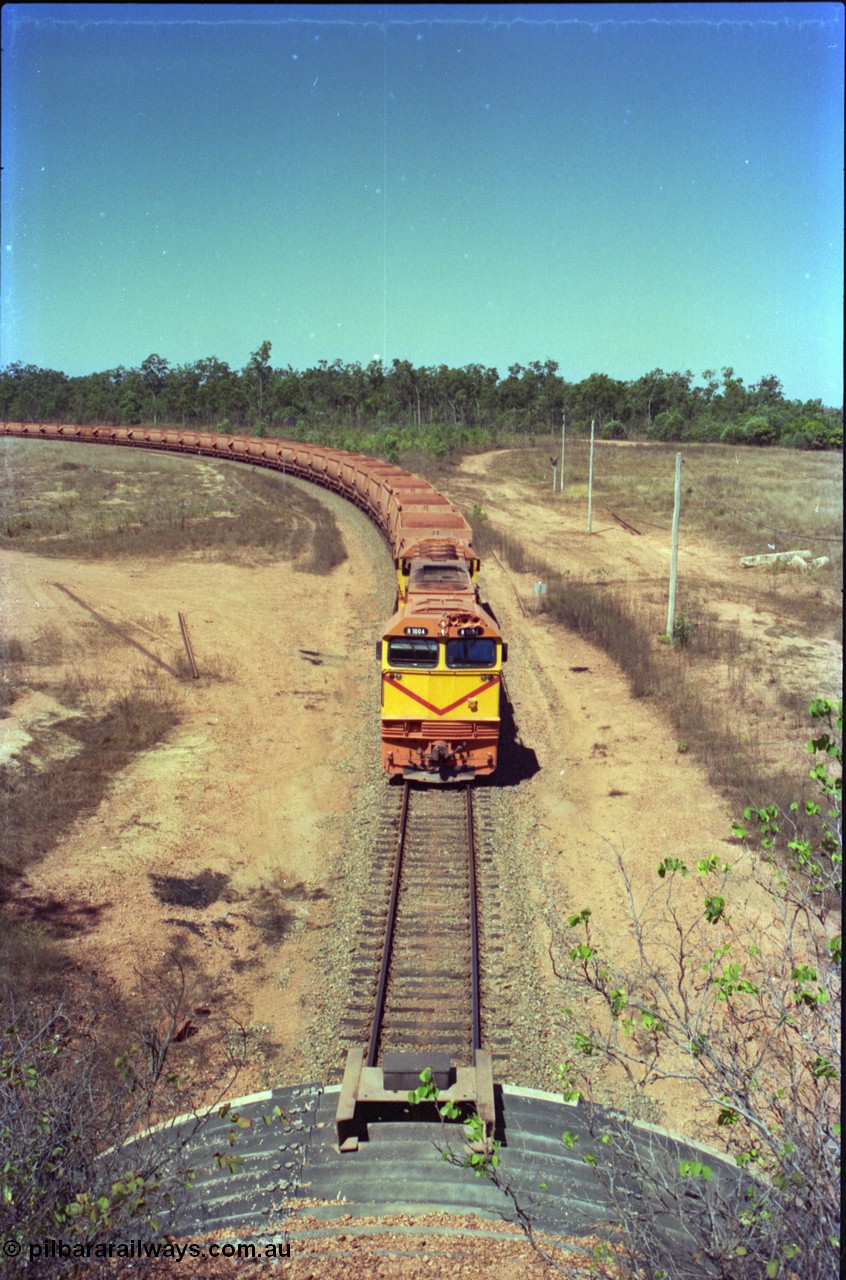 212-13
Weipa, a loaded train arrives back from Andoom Mine at the road overbridge at Lorim Point behind Comalco R 1004 Clyde Engineering EMD JT26C serial 90-1277 which is former Goldsworthy Mining loco GML 10.
Keywords: R1004;Clyde-Engineering-Kelso-NSW;EMD;JT26C;90-1277;Comalco;GML10;Cinderella;GML-class;