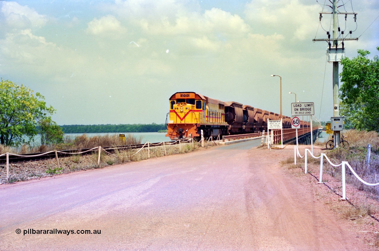 212-17
Comalco Clyde Engineering built EMD model GT26C unit R 1001 serial 72-752 originally numbered 1.001 and built in 1972 heads an empty train towards Andoom seen here coming off the Mission River Bridge at the 9 km. July 1995.
Keywords: R1001;Clyde-Engineering;EMD;GT26C;72-752;1.001;Comalco;