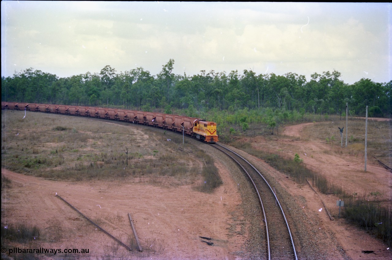 212-19
Weipa, a loaded train from Andoom Mine rounds the curve on approach to Lorim Point behind a long end leading Comalco R 1001 Clyde Engineering built EMD model GT26C serial 72-752 originally numbered 1.001 and built in 1972. July 1995.
Keywords: R1001;Clyde-Engineering;EMD;GT26C;72-752;1.001;Comalco;