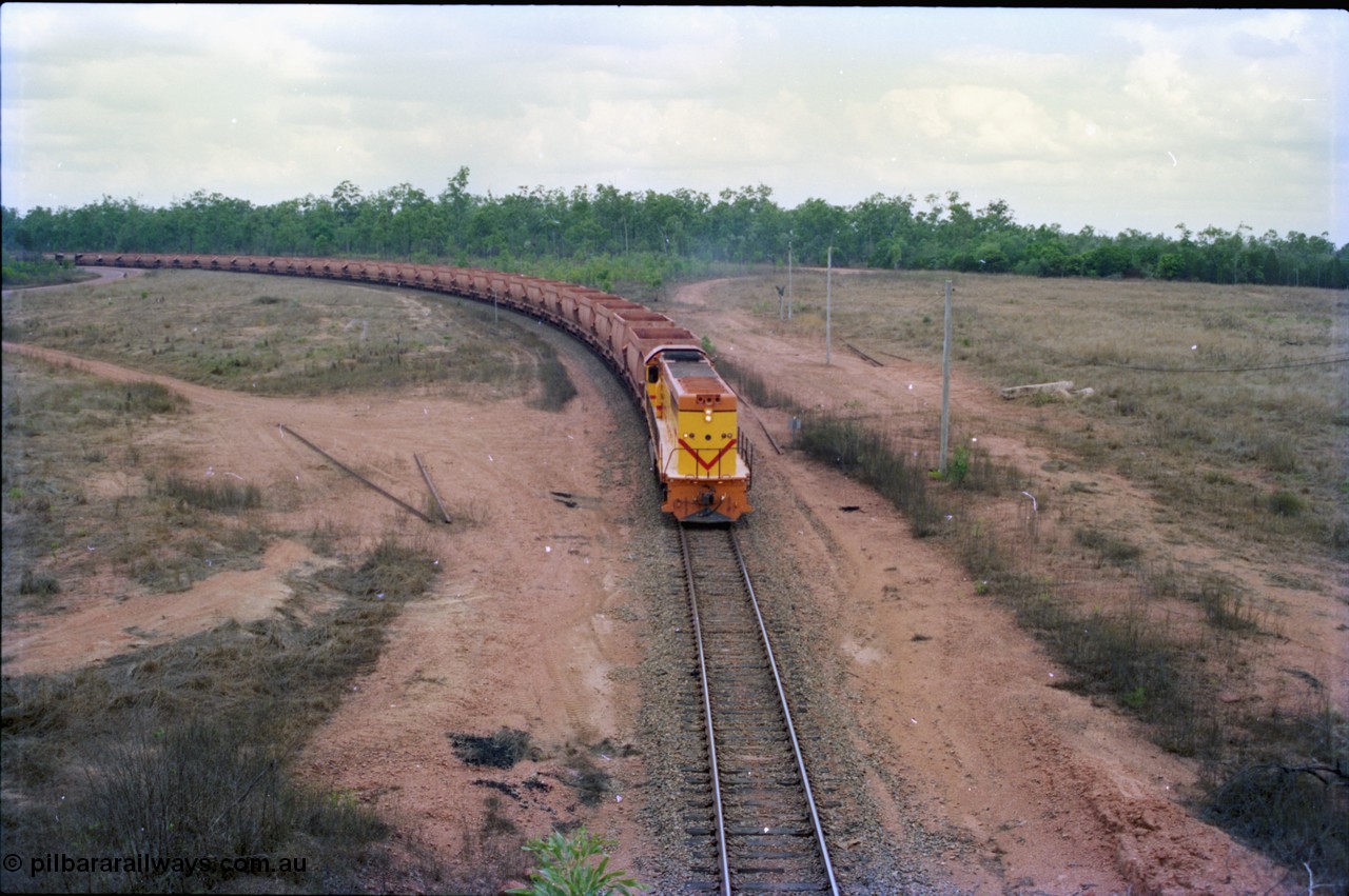 212-20
Weipa, a loaded train from Andoom Mine rounds the curve on approach to Lorim Point behind a long end leading Comalco R 1001 Clyde Engineering built EMD model GT26C serial 72-752 originally numbered 1.001 and built in 1972. July 1995.
Keywords: R1001;Clyde-Engineering;EMD;GT26C;72-752;1.001;Comalco;