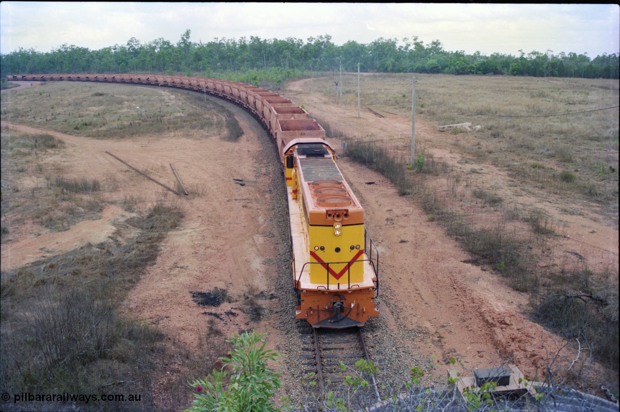 212-21
Weipa, a loaded train from Andoom Mine rounds the curve on approach to Lorim Point behind a long end leading Comalco R 1001 Clyde Engineering built EMD model GT26C serial 72-752 originally numbered 1.001 and built in 1972. July 1995.
Keywords: R1001;Clyde-Engineering;EMD;GT26C;72-752;1.001;Comalco;