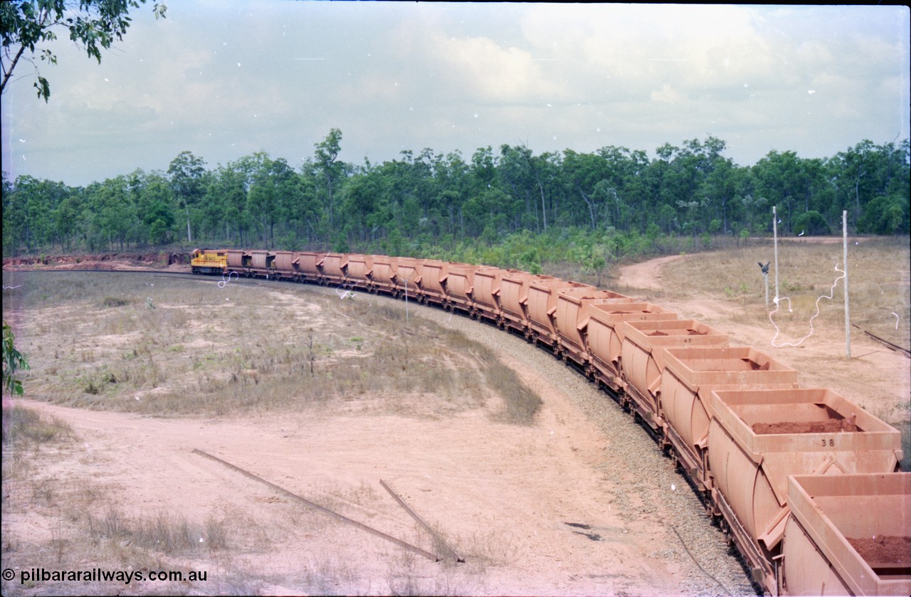 212-26
Weipa, empty train departs Lorim Point around the curve with another run to the mine at Andoom behind Comalco R 1001 Clyde Engineering built EMD model GT26C serial 72-752 originally numbered 1.001 and built in 1972. July 1995.
