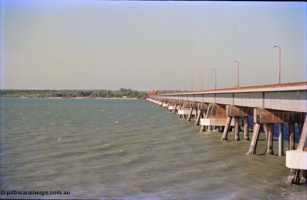 212-27
Weipa, Mission River road and rail bridge from the Andoom and rail side with an empty train headed by Comalco unit R 1004 purchased off BHP Iron Ore in 1994 is a Clyde Engineering built EMD model JT42C built in 1990 with serial 90-1277. July 1995.
Keywords: R1004;Clyde-Engineering-Kelso-NSW;EMD;JT26C;90-1277;Comalco;GML10;Cinderella;GML-class;