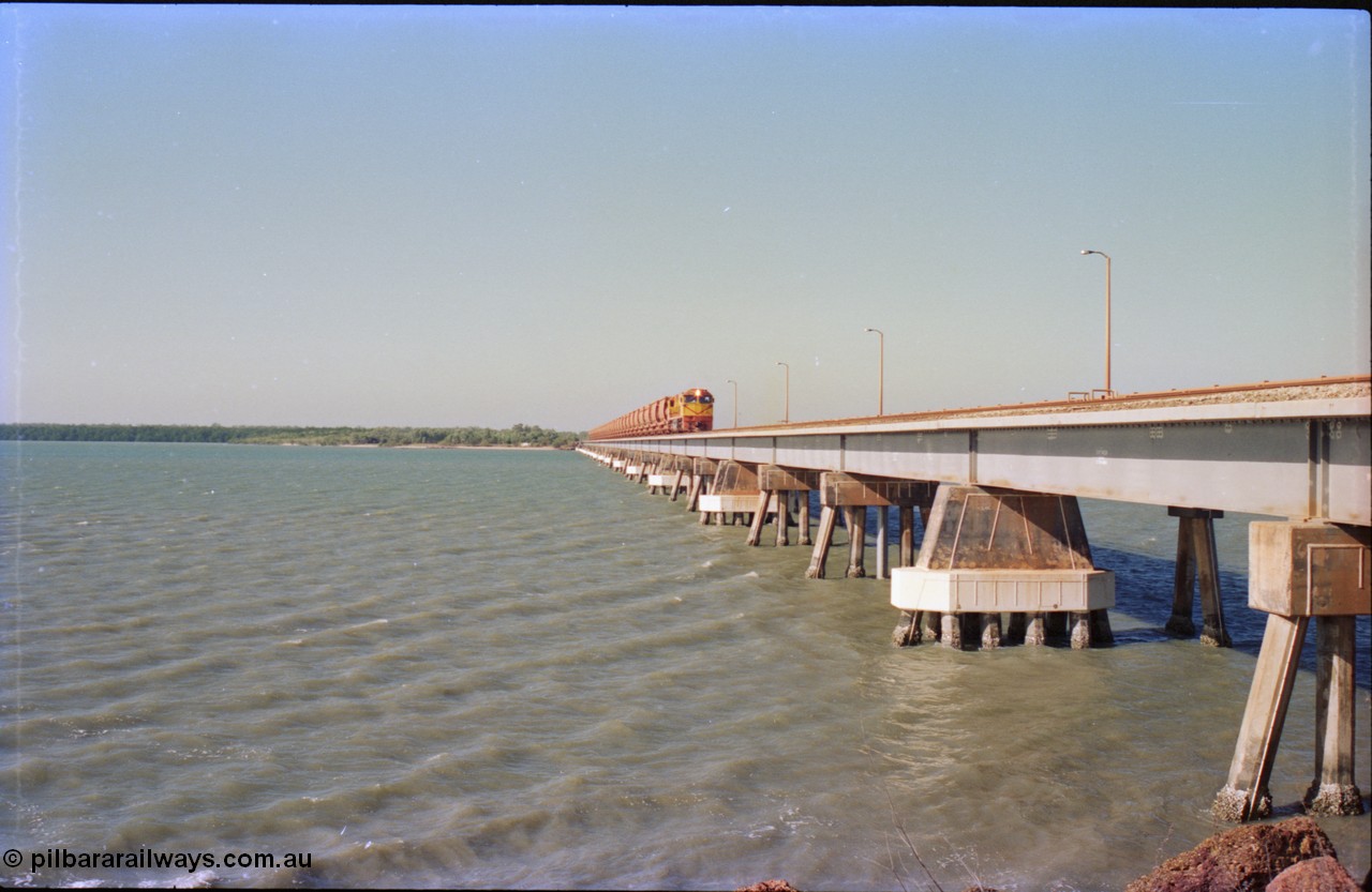 212-29
Weipa, Mission River road and rail bridge from the Andoom and rail side with an empty train headed by Comalco unit R 1004 purchased off BHP Iron Ore in 1994 is a Clyde Engineering built EMD model JT42C built in 1990 with serial 90-1277. July 1995.
Keywords: R1004;Clyde-Engineering-Kelso-NSW;EMD;JT26C;90-1277;Comalco;GML10;Cinderella;GML-class;