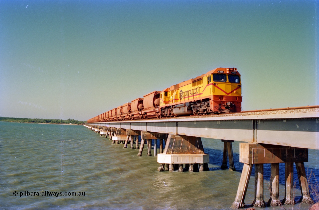 212-30
Comalco unit R 1004 purchased off BHP Iron Ore in 1994 is a Clyde Engineering built EMD model JT42C built in 1990 with serial 90-1277 leading an empty towards Andoom across the Mission River Bridge at high tide. July 1995.
Keywords: R1004;Clyde-Engineering-Kelso-NSW;EMD;JT26C;90-1277;Comalco;GML10;Cinderella;GML-class;