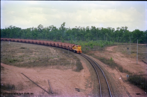 212-19
Weipa, a loaded train from Andoom Mine rounds the curve on approach to Lorim Point behind a long end leading Comalco R 1001 Clyde Engineering built EMD model GT26C serial 72-752 originally numbered 1.001 and built in 1972. July 1995.
Keywords: R1001;Clyde-Engineering;EMD;GT26C;72-752;1.001;Comalco;