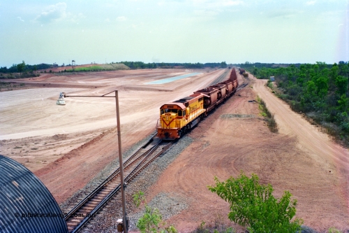 212-25
Comalco Clyde Engineering built EMD model GT26C unit R 1001 serial 72-752 originally numbered 1.001 and built in 1972 leads an empty train as it powers away from Lorim Point bound for Andoom. July 1995.
Keywords: R1001;Clyde-Engineering;EMD;GT26C;72-752;1.001;Comalco;