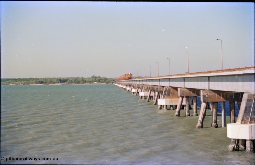 212-28
Weipa, Mission River road and rail bridge from the Andoom and rail side with an empty train headed by Comalco unit R 1004 purchased off BHP Iron Ore in 1994 is a Clyde Engineering built EMD model JT42C built in 1990 with serial 90-1277. July 1995.
Keywords: R1004;Clyde-Engineering-Kelso-NSW;EMD;JT26C;90-1277;Comalco;GML10;Cinderella;GML-class;