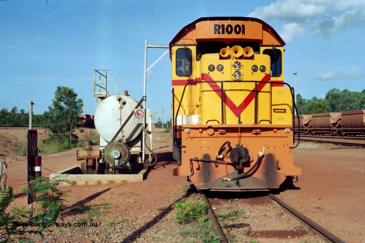 213-01
Weipa, Lorim Point workshops looking east, Comalco R 1001 loco Clyde Engineering built EMD model GT26C serial 72-752 sits at the fuel point, items of note are these units were setup to have the long hood leading, the second 'tropical roof' and the five chime horn cut into the nose. This unit is almost identical to the GT26C models of the WAGR L class. September 1995.
Keywords: R1001;Clyde-Engineering;EMD;GT26C;72-752;1.001;Comalco;