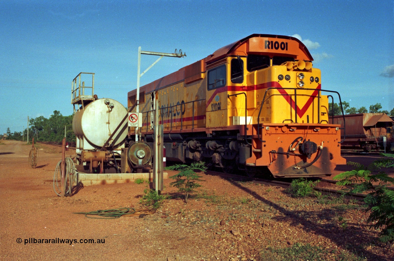 213-17
Weipa, Lorim Point workshops, Comalco R 1001 loco Clyde Engineering built EMD model GT26C serial 72-752 sits at the fuel point, items of note are these units were setup to have the long hood leading, the second 'tropical roof' and the five chime horn cut into the nose. Also noticeable, the units don't have dynamic brakes fitted so there is no brake 'blister' in the middle of the hood like you see on the GT26C models of WAGR L or VR C classes.
Keywords: R1001;Clyde-Engineering;EMD;GT26C;72-752;1.001;Comalco;