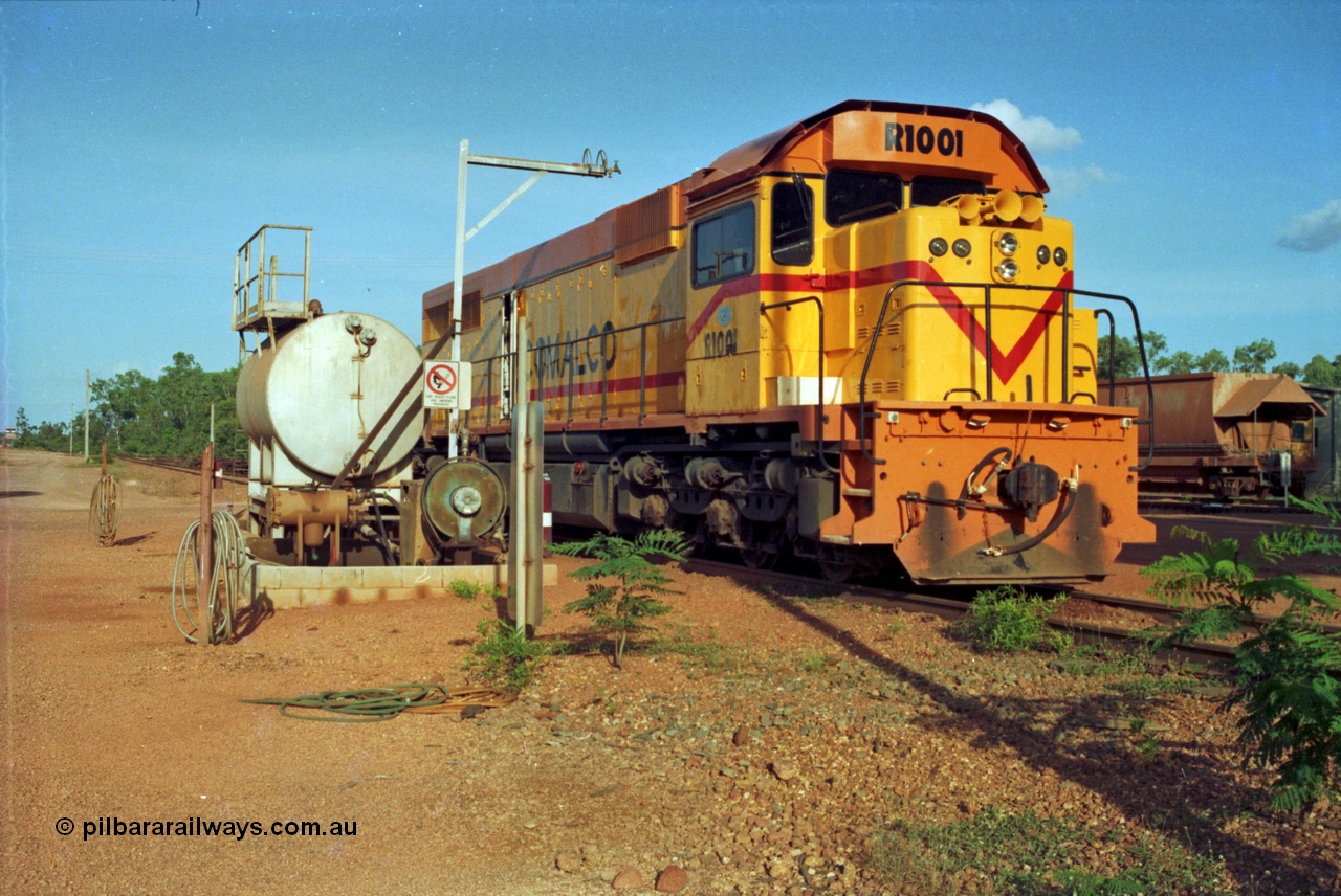 213-18
Weipa, Lorim Point workshops, Comalco R 1001 loco Clyde Engineering built EMD model GT26C serial 72-752 sits at the fuel point, items of note are these units were setup to have the long hood leading, the second 'tropical roof' and the five chime horn cut into the nose. Also noticeable, the units don't have dynamic brakes fitted so there is no brake 'blister' in the middle of the hood like you see on the GT26C models of WAGR L or VR C classes.
Keywords: R1001;Clyde-Engineering;EMD;GT26C;72-752;1.001;Comalco;