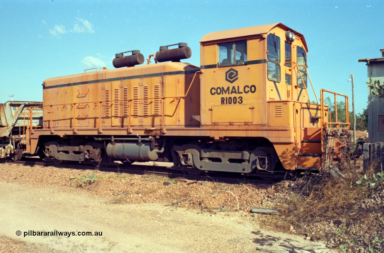 213-26
Weipa, Lorim Point railway workshops. Comalco shunt engine R 1003 coupled to a Difco side dump waggon. R 1003 is an Electro Motive built NW2 model with serial number 4114 and frame number of E761-8 was built in November 1946 at La Grange originally for Canadian National with road number 7943. Sold to Comalco in December 1975 and entered service in 1976. This unit was subsequently scrapped in 2000.
Keywords: R1003;EMD;NW2;4114;E761-8;Comalco;Canadian-National;