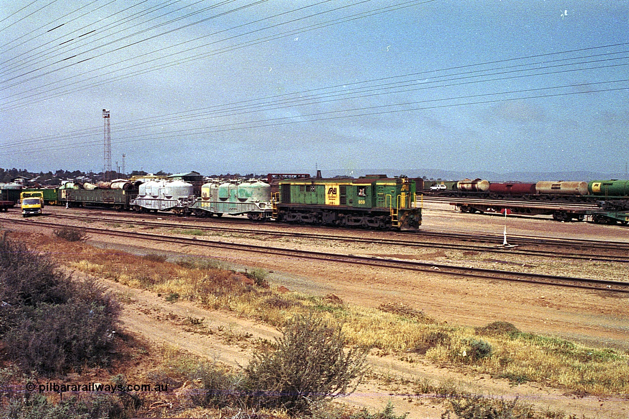 215-05
Port Augusta, AN liveried 830 class locomotive 859 AE Goodwin ALCo model DL531 serial 84705 performs shunting duties in the yard.
Keywords: 830-class;859;AE-Goodwin;ALCo;DL531;84705;