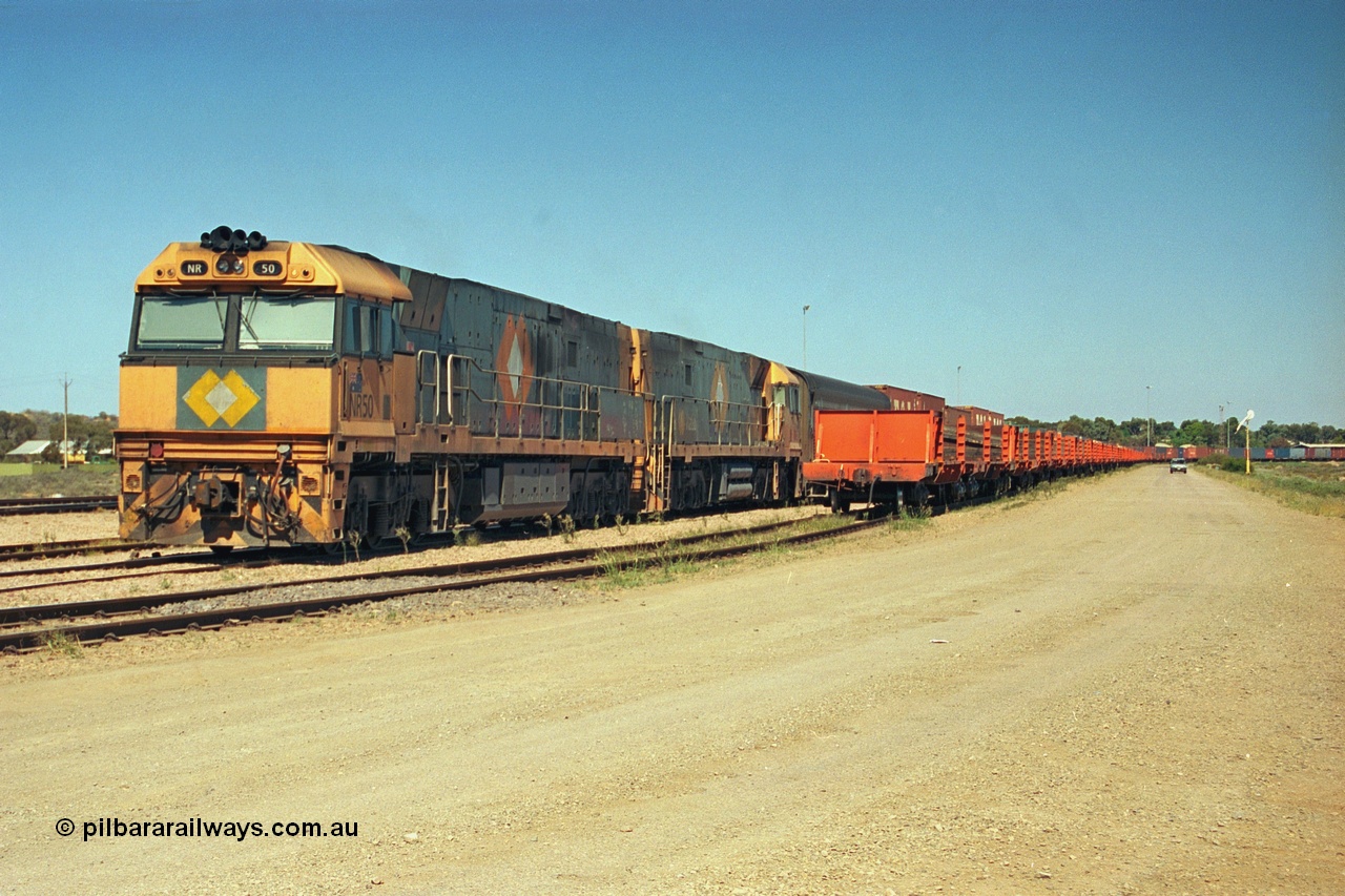 244-01
Port Augusta yard, an SP service waits for departure time next to a rack or rail transport waggons for the Darwin line construction headed up by NR class NR 50, a Goninan built GE Cv40-9i model, serial 7250-08/97-252.
Keywords: NR-class;NR50;Goninan;GE;Cv40-9i;7250-08/97-252;