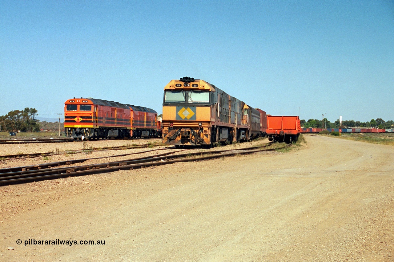 244-02
Port Augusta yard, a pair of ALF class units on the Darwin line construction shunt a rail transport waggon as an SP service wait for departure time with a pair of NR class units. ALF 20 and ALF 18 are both Morrison Knudsen rebuilds, model JT26C-2M serials 94-AN-020 and 94-AN-018.
Keywords: ALF-class;ALF18;ALF20;MKA;EMD;JT26C-2M;94-AN-018;94-AN-020;rebuild;AL-class;NR-class;NR50;Goninan;GE;Cv40-9i;7250-08/97-252;