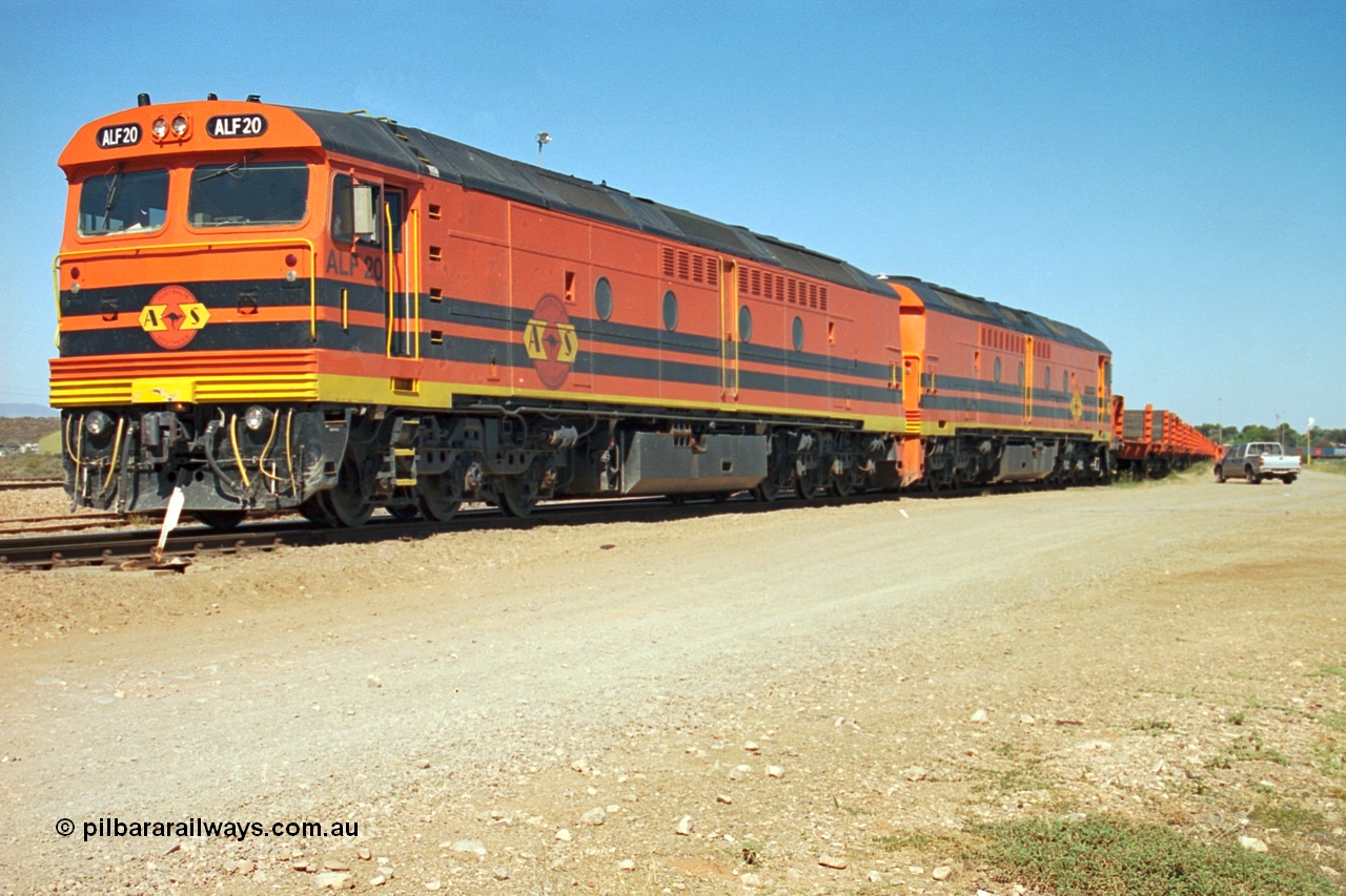 244-06
Port Augusta yard, a pair of ALF class units on the Darwin line construction are picking up a rail transport consist. ALF 20 and ALF 18 are both Morrison Knudsen rebuilds, model JT26C-2M serials 94-AN-020 and 94-AN-018.
Keywords: ALF-class;ALF18;ALF20;MKA;EMD;JT26C-2M;94-AN-018;94-AN-020;AL-class;