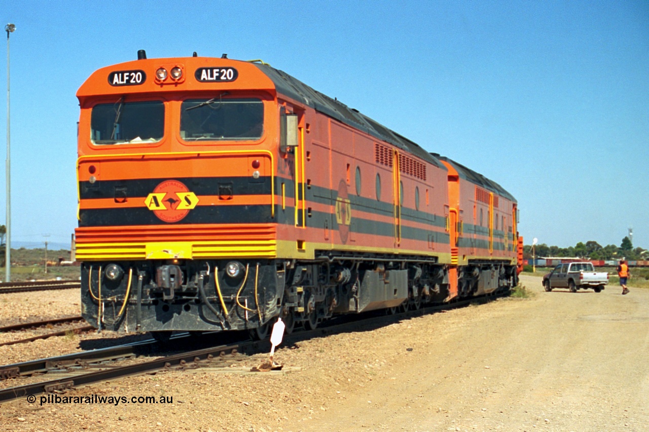 244-07
Port Augusta yard, a pair of ALF class units on the Darwin line construction are picking up a rail transport consist. ALF 20 and ALF 18 are both Morrison Knudsen rebuilds, model JT26C-2M serials 94-AN-020 and 94-AN-018.
Keywords: ALF-class;ALF18;ALF20;MKA;EMD;JT26C-2M;94-AN-018;94-AN-020;rebuild;AL-class;Clyde-Engineering;EMD;JT26C;