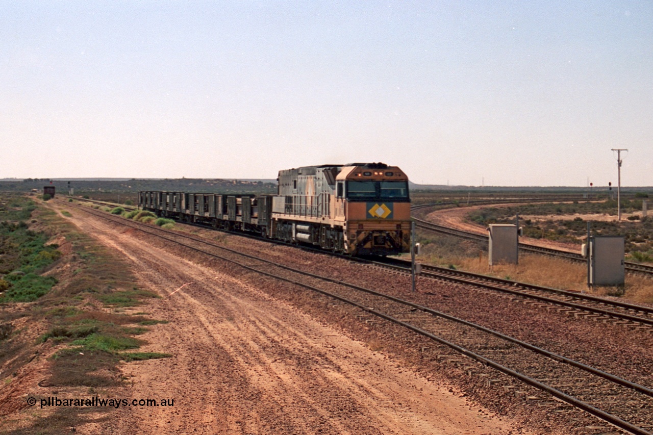 244-11
Port Augusta, Spencer Junction NR class NR 22 leads an UP short four waggon steel train off the Whyalla line. NR 22 is a Goninan built GE model Cv40-9i serial 7250-04/97-224.
