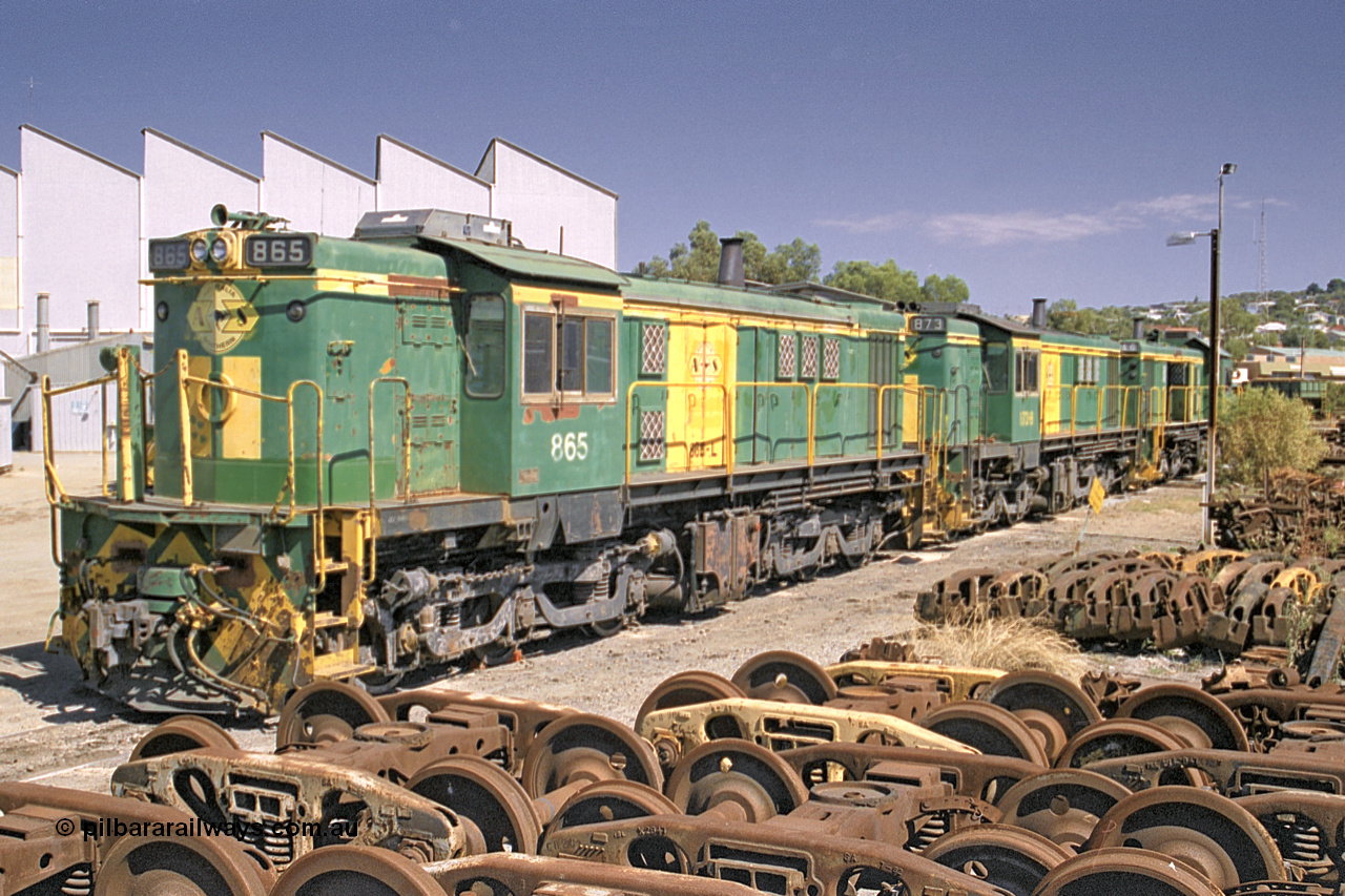245-05
Port Lincoln loco workshops, still in former owner AN livery, Australian Southern 830 class locomotive 865 AE Goodwin ALCo model DL531 serial 84711, roster shot in multi-unit consist with sister unit 873 and DA class unit DA 6. 6th April 2003.
Keywords: 830-class;865;AE-Goodwin;ALCo;DL531;84711;