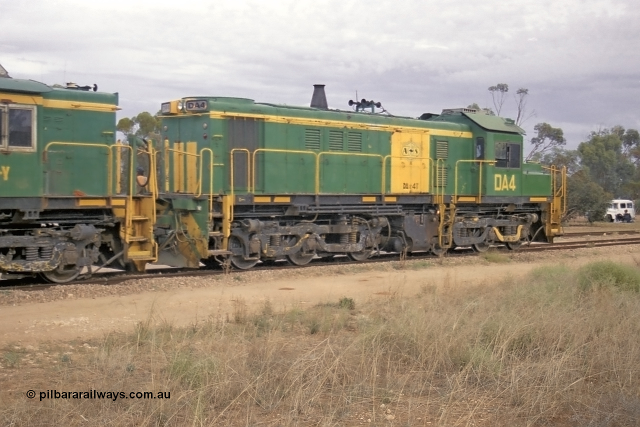 245-13
Wudinna, empty grain train behind a trio of former Australian National locomotives with rebuilt former AE Goodwin ALCo model DL531 830 class ex 839, serial 83730, rebuilt by Port Augusta Workshops to DA class, DA 4 leading two AE Goodwin ALCo model DL531 830 class units 842, serial 84140 and 851 serial 84137, 851 having been on the Eyre Peninsula since delivered in 1962, to shunt off empty waggons into the grain siding. 7th April 2003.
Keywords: DA-class;DA4;83730;Port-Augusta-WS;ALCo;DL531G/1;830-class;839;rebuild;