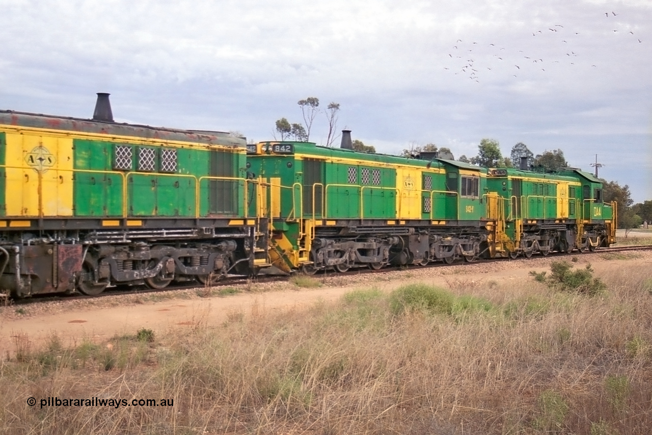 245-14
Wudinna, empty grain train shunts a rake of waggons before backing them into the grain siding, former Australian National Co-Co locomotives AE Goodwin ALCo model DL531 830 class units 842, serial no. 84140 and 851 serial no. 84137, 851 having been on the Eyre Peninsula since delivered in 1962. 7th April, 2003.
Keywords: 830-class;842;84140;AE-Goodwin;ALCo;DL531;