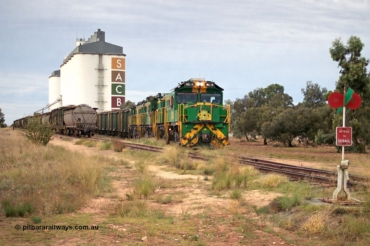 245-16
Wudinna, empty grain train shunts back into the grain siding with a trio of former Australian National Co-Co locomotives with rebuilt former AE Goodwin ALCo model DL531 830 class ex 839, serial no. 83730, rebuilt by Port Augusta Workshops to DA class, DA 4 leading two AE Goodwin ALCo model DL531 830 class units 842, serial no. 84140 and 851 serial no. 84137, 851 having been on the Eyre Peninsula since delivered in 1962. 7th April, 2003.
Keywords: DA-class;DA4;83730;Port-Augusta-WS;ALCo;DL531G/1;830-class;839;rebuild;