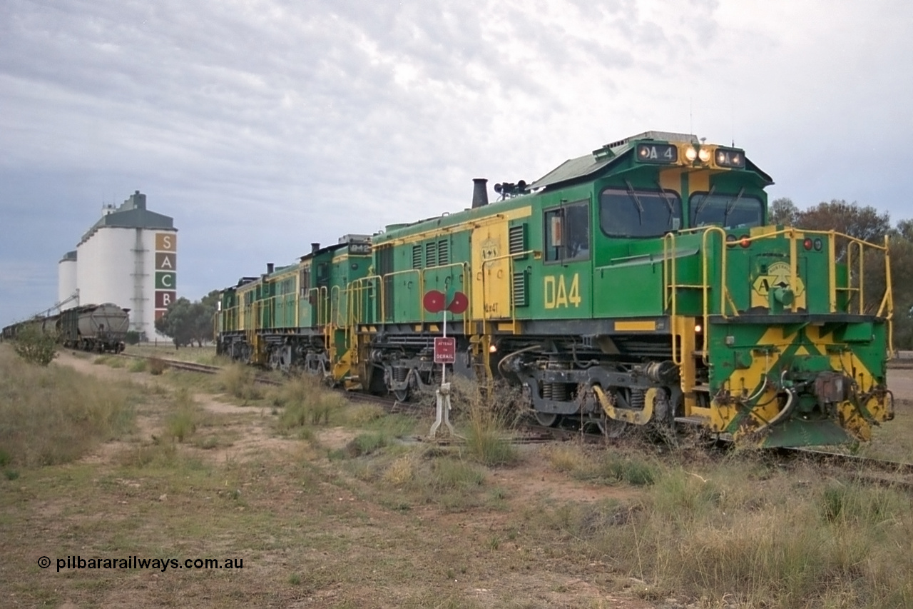 245-21
Wudinna, empty grain train locos shunt back towards the mainline having dropped waggons in the siding, a trio of former Australian National Co-Co locomotives with rebuilt former AE Goodwin ALCo model DL531 830 class ex 839, serial no. 83730, rebuilt by Port Augusta Workshops to DA class, DA 4 leading two AE Goodwin ALCo model DL531 830 class units 842, serial no. 84140 and 851 serial no. 84137, 851 having been on the Eyre Peninsula since delivered in 1962. 7th April, 2003.
Keywords: DA-class;DA4;83730;Port-Augusta-WS;ALCo;DL531G/1;830-class;839;rebuild;