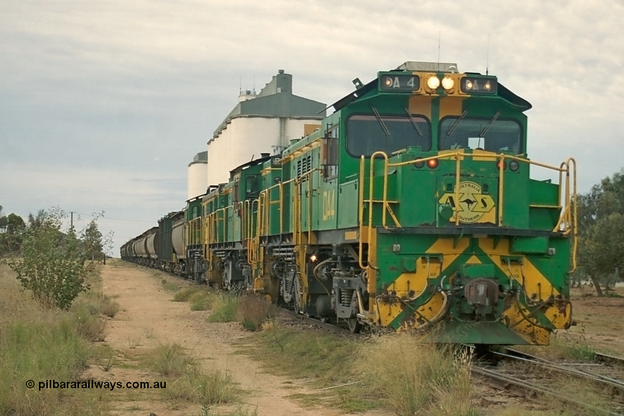 245-23
Wudinna, empty grain stands on the main awaiting departure north with a trio of former Australian National Co-Co locomotives with rebuilt former AE Goodwin ALCo model DL531 830 class ex 839, serial no. 83730, rebuilt by Port Augusta Workshops to DA class, leading two AE Goodwin ALCo model DL531 830 class units 842, serial no. 84140 and 851 serial no. 84137, 851 having been on the Eyre Peninsula since delivered in 1962. 7th April, 2003.
Keywords: DA-class;DA4;83730;Port-Augusta-WS;ALCo;DL531G/1;830-class;839;rebuild;