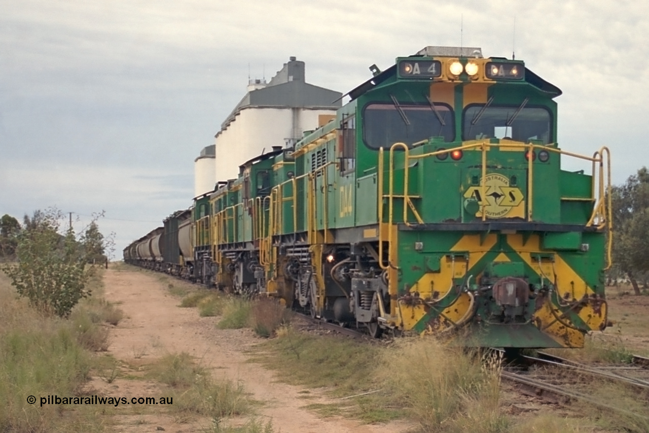 245-24
Wudinna, empty grain stands on the main awaiting departure north with a trio of former Australian National Co-Co locomotives with rebuilt former AE Goodwin ALCo model DL531 830 class ex 839, serial no. 83730, rebuilt by Port Augusta Workshops to DA class, leading two AE Goodwin ALCo model DL531 830 class units 842, serial no. 84140 and 851 serial no. 84137, 851 having been on the Eyre Peninsula since delivered in 1962. 7th April, 2003.
Keywords: DA-class;DA4;83730;Port-Augusta-WS;ALCo;DL531G/1;830-class;839;rebuild;