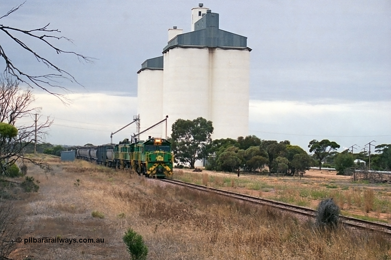 245-25
Yaninee, empty grain train behind a trio of former Australian National Co-Co locomotives with rebuilt former AE Goodwin ALCo model DL531 830 class ex 839, serial no. 83730, rebuilt by Port Augusta Workshops to DA class, leading two AE Goodwin ALCo model DL531 830 class units 842, serial no. 84140 and 851 serial no. 84137, 851 having been on the Eyre Peninsula since delivered in 1962, runs through express on the mainline. 7th April, 2003.
Keywords: DA-class;DA4;83730;Port-Augusta-WS;ALCo;DL531G/1;830-class;839;rebuild;