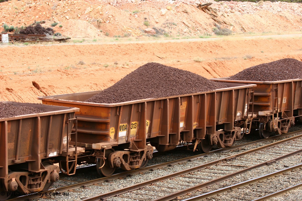 060116 2688
WOA type iron ore waggon WOA 31335 is one of a batch of thirty nine built by WAGR Midland Workshops between 1970 and 1971 with fleet number 215 for Koolyanobbing iron ore operations, with a 75 ton and 1018 ft³ capacity, seen here with lump ore at West Kalgoorlie 16th January 2006.
Keywords: WOA-type;WOA31335;WAGR-Midland-WS;