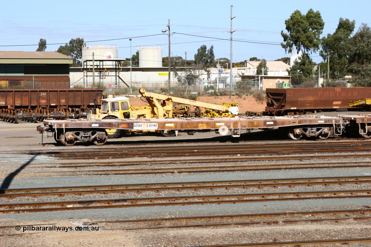 060528 4439
West Kalgoorlie, looking across to the waggon repair facility, in the foreground is flat waggon AFBF 33178 modified for kibble service originally built by WAGR Midland Workshops in 1970 as a WGX type open waggon, but behind is red carded WO type waggon WO 31286 with fleet number 166 and WOE type WOE 33256 with fleet number 755. 28th May 2006.
Keywords: AFBF-type;AFBF33178;WAGR-Midland-WS;WGX-type;