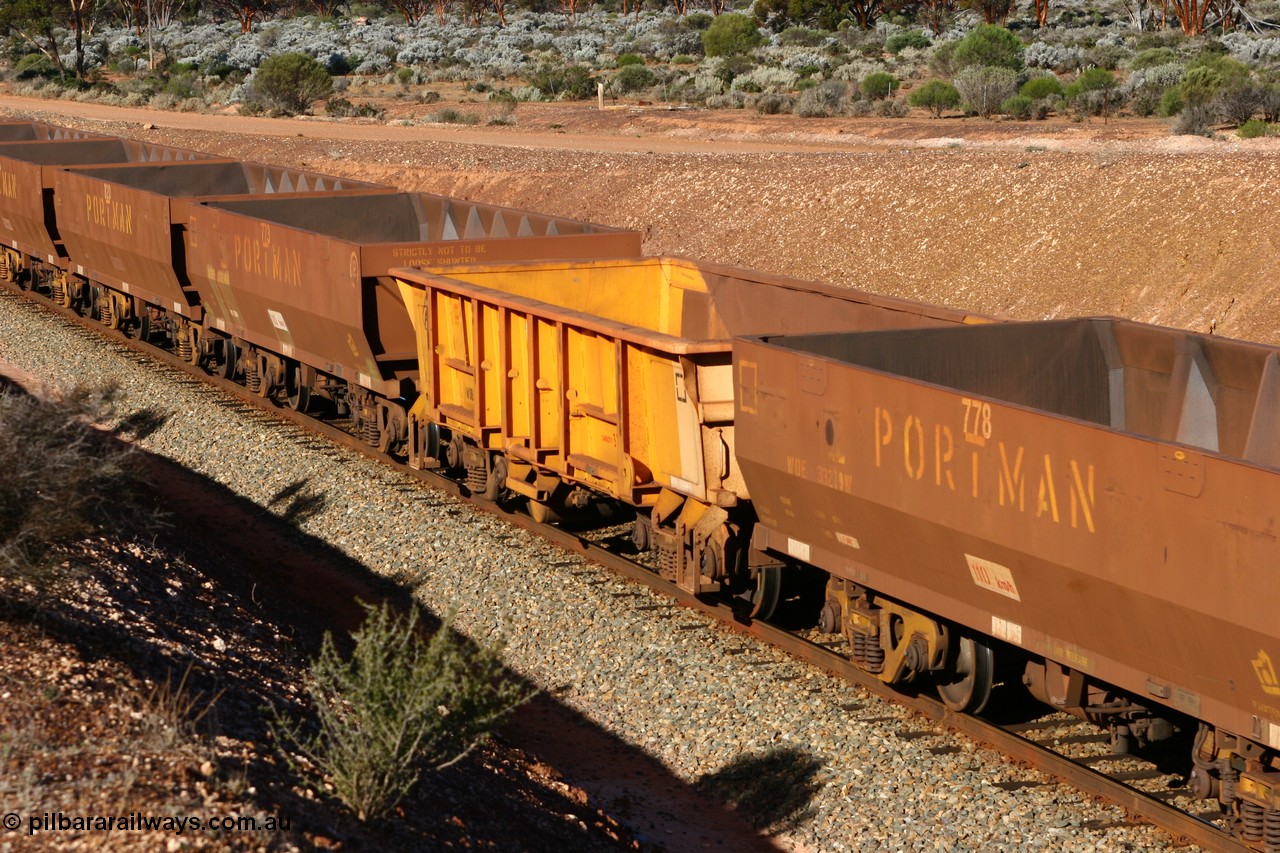 060528 4614
WOB type iron ore waggon WOB 31395 is one of a batch of twenty five built by Comeng WA between 1974 and 1975 and converted from Mt Newman high sided waggons by WAGR Midland Workshops with a capacity of 67 tons with fleet number 325 for Koolyanobbing iron ore operations. This waggon was also converted to a WSM type ballast hopper by re-fitting the cut down top section and having bottom discharge doors fitted, converted back to WOB in 1997, and this is the first one to be repainted in ARG yellow and stands out against the newer style WOE type waggons as this empty train runs past the 628 km west of Bonnie Vale, 28th May 2006.
Keywords: WOB-type;WOB31395;Comeng-WA;WSM-type;Mt-Newman-Mining;