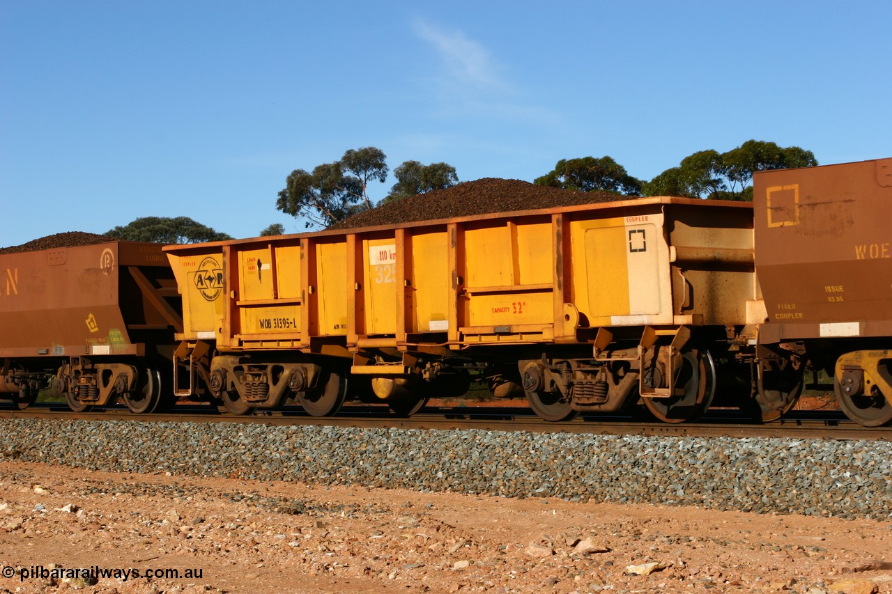 060530 4971
WOB type iron ore waggon WOB 31395 is one of a batch of twenty five built by Comeng WA between 1974 and 1975 and converted from Mt Newman high sided waggons by WAGR Midland Workshops with a capacity of 67 tons with fleet number 325 for Koolyanobbing iron ore operations. This waggon was also converted to a WSM type ballast hopper by re-fitting the cut down top section and having bottom discharge doors fitted, converted back to WOB in 1997, and later converted to a WSM type ballast hopper, then back to its current guise, and this is the first one to be repainted in ARG yellow, shows capacity of 32M³, loaded with lump ore, Binduli 30th May 2006.
Keywords: WOB-type;WOB31395;Comeng-WA;WSM-type;Mt-Newman-Mining;